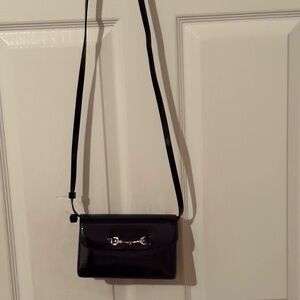 Sam Edelman black Lorraine crossbody has magnetic closure.